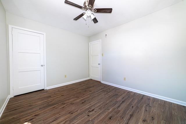 spare room with ceiling fan and dark wood-type flooring