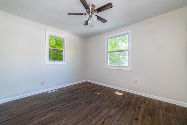 spare room with dark hardwood / wood-style floors and ceiling fan