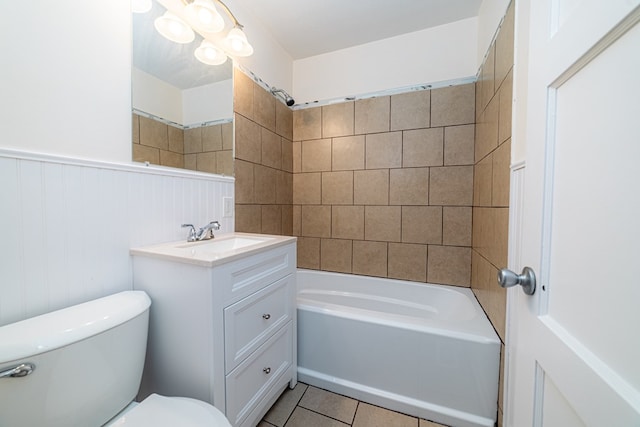 full bathroom with tile patterned flooring, tiled shower / bath combo, toilet, and vanity