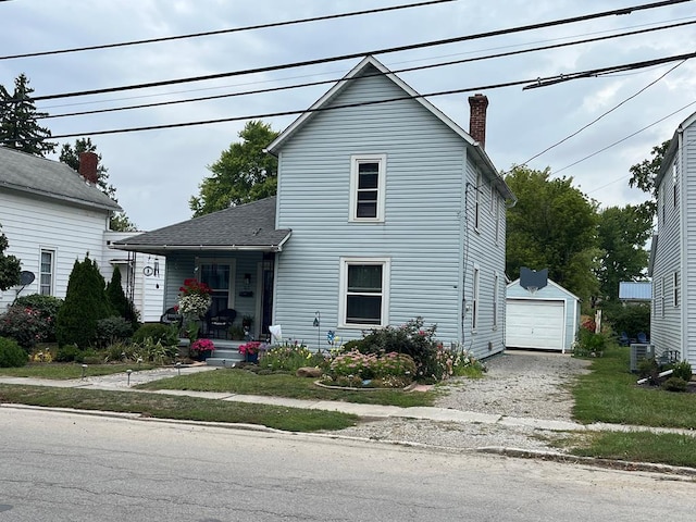 view of front property with an outbuilding and a garage