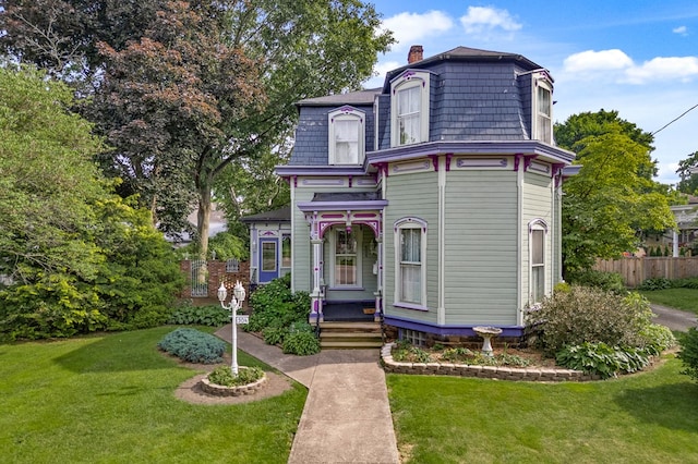 victorian-style house featuring a front lawn