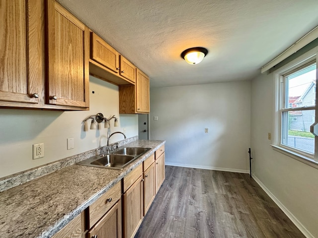 184 Mason St, Mansfield, OH 44902 - kitchen featuring dark wood-style flooring, light countertops, a textured ceiling, and brown cabinets