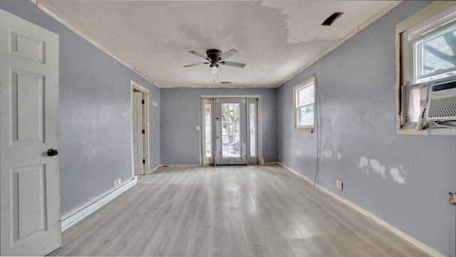 foyer featuring cooling unit, baseboards, light wood-style flooring, and a ceiling fan