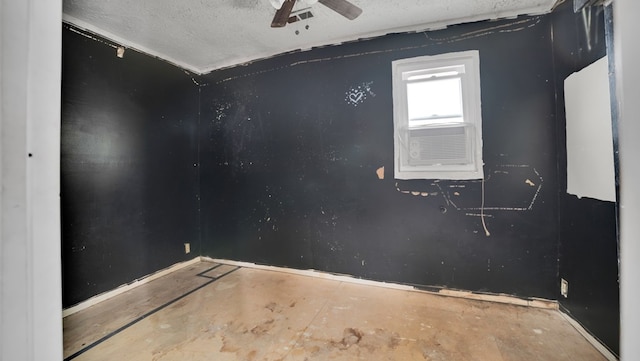 spare room with a textured ceiling and ceiling fan