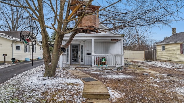 exterior space with fence, covered porch, and driveway