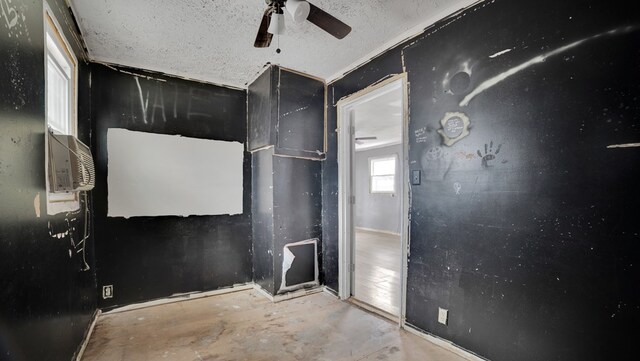 interior space with ceiling fan and a textured ceiling