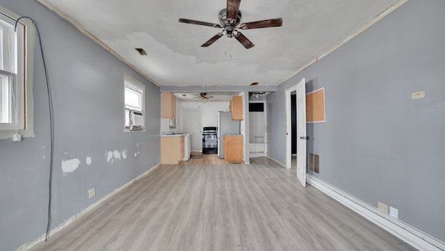 unfurnished living room featuring visible vents, light wood-style flooring, baseboards, and a ceiling fan