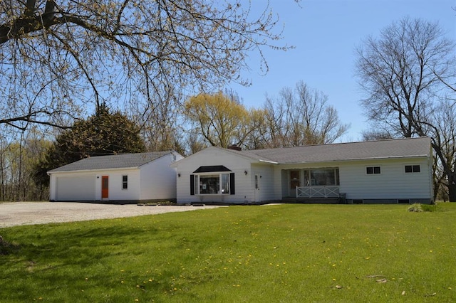 ranch-style home with a front lawn, a garage, and driveway