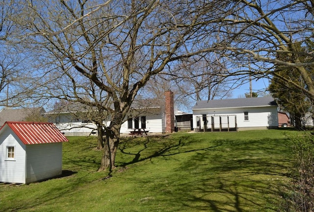 view of yard with a storage shed and an outbuilding