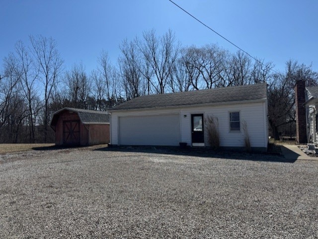 garage featuring a storage shed