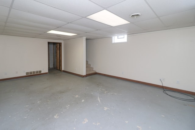 basement with a paneled ceiling