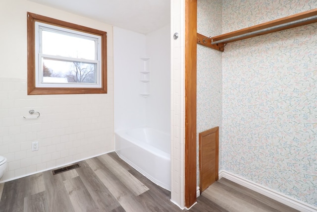 bathroom featuring wood-type flooring and toilet