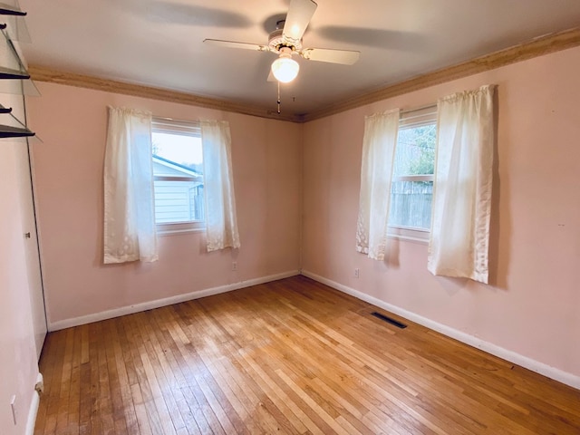 unfurnished room featuring ceiling fan, light hardwood / wood-style flooring, and crown molding