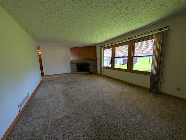unfurnished living room with a fireplace with raised hearth, visible vents, light carpet, and baseboards