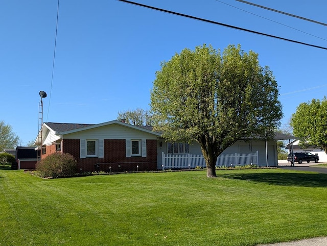 single story home with a front lawn and brick siding