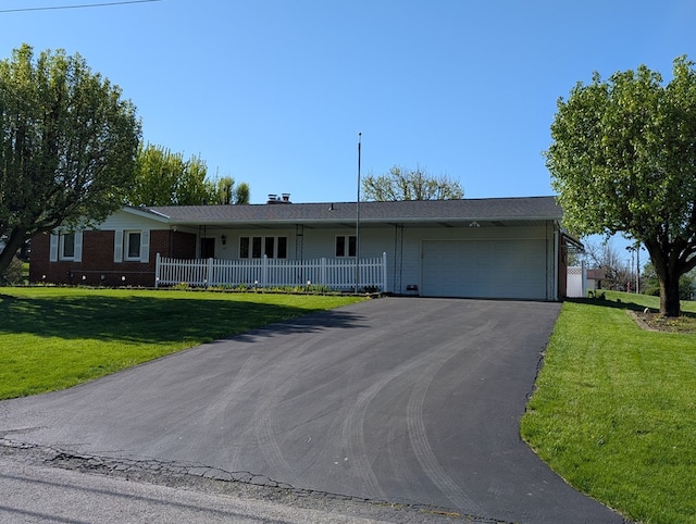 ranch-style home with a front lawn, driveway, an attached garage, and brick siding