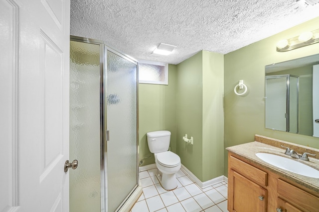 full bath with vanity, a stall shower, tile patterned flooring, a textured ceiling, and toilet