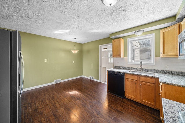 kitchen with dark wood-style floors, backsplash, stainless steel appliances, and a sink