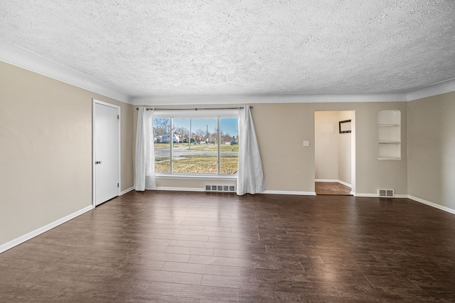 unfurnished living room with a textured ceiling, wood finished floors, visible vents, and baseboards