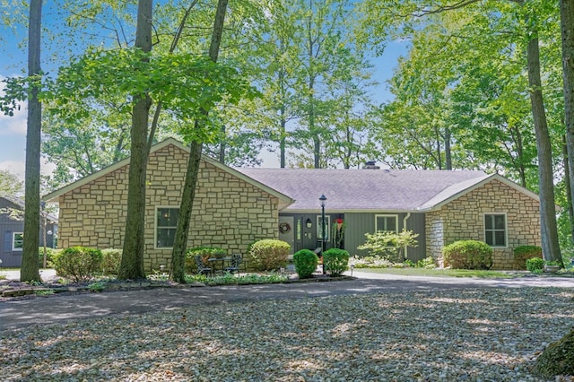 7326 State Route 19 Unit 27-30, Mount Gilead, OH 43338 - view of front of home with stone siding, roof with shingles, and a chimney