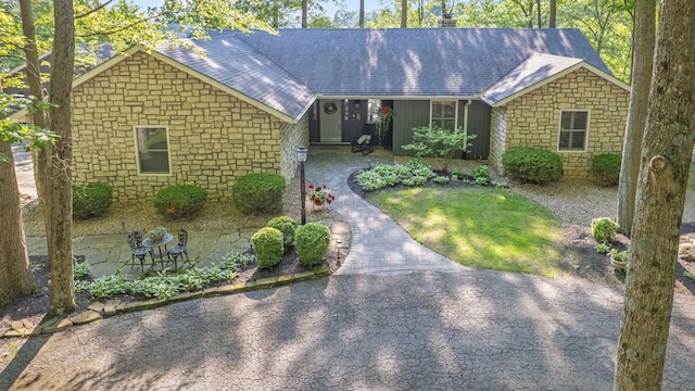7326 State Route 19 Unit 27-30, Mount Gilead, OH 43338 - ranch-style home featuring stone siding, a chimney, roof with shingles, and asphalt driveway