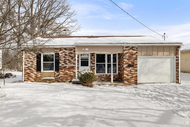 view of front of home featuring a garage, brick siding, and board and batten siding