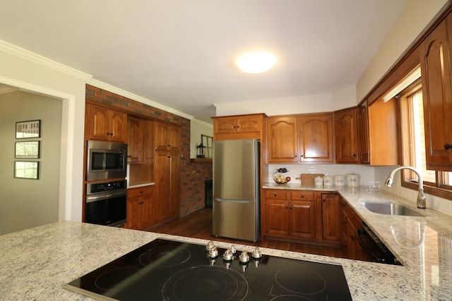 4107 State Route 113, Milan, OH 44846 - kitchen featuring crown molding, a sink, black appliances, light stone countertops, and wood finished floors