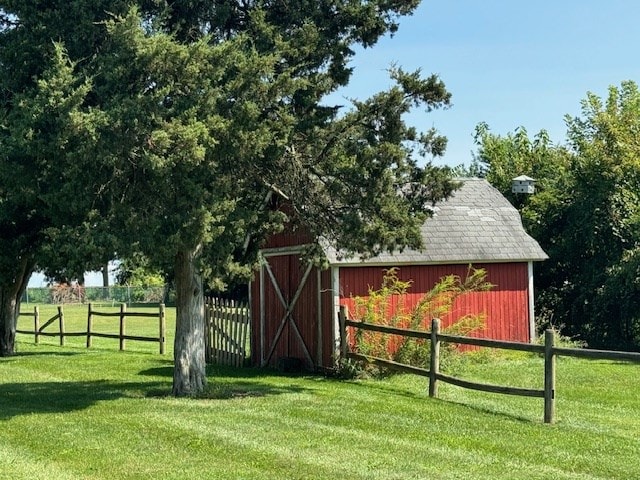 view of outbuilding featuring a lawn