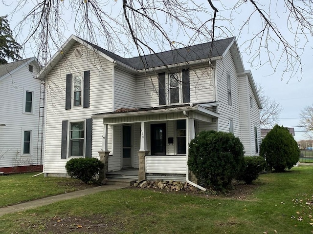 view of front of property with covered porch and a front yard