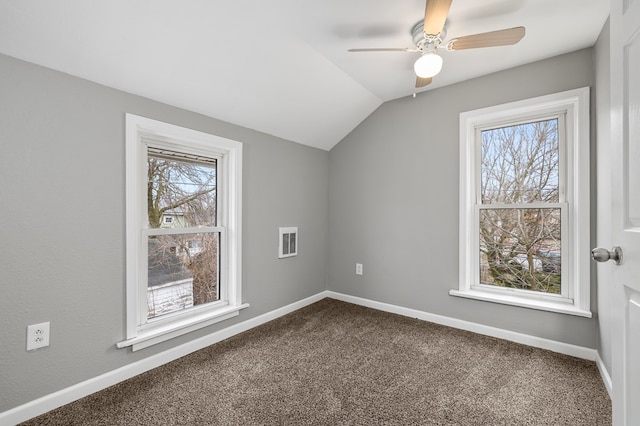 bonus room with baseboards, dark carpet, and vaulted ceiling