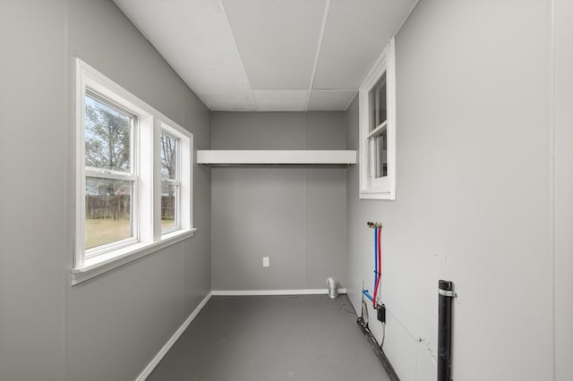 clothes washing area with laundry area, hookup for a washing machine, and baseboards