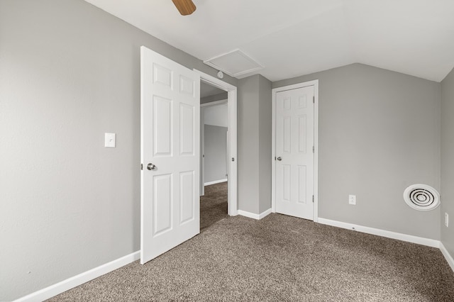 unfurnished bedroom featuring carpet flooring, visible vents, baseboards, vaulted ceiling, and attic access