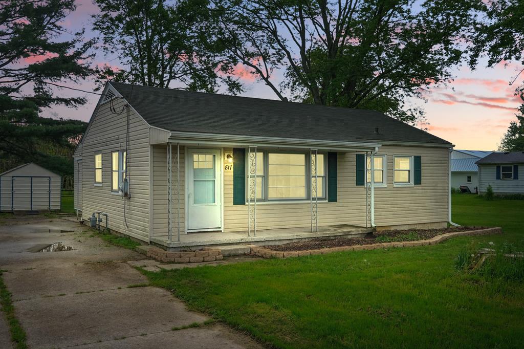 817 Crew Ave, Galion, OH 44833 - view of front of house with a porch, a storage shed, an outbuilding, a front yard, and driveway