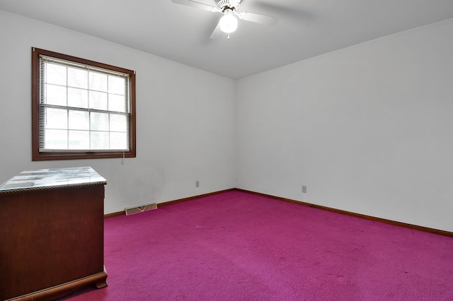 empty room featuring light colored carpet and ceiling fan