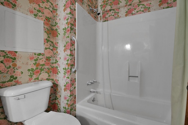 bathroom featuring shower / bathtub combination and toilet