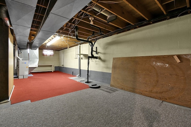 basement with carpet and heating unit