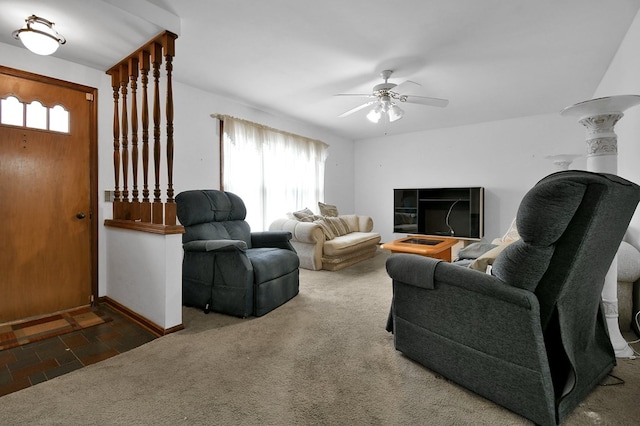 living room featuring ceiling fan and dark colored carpet