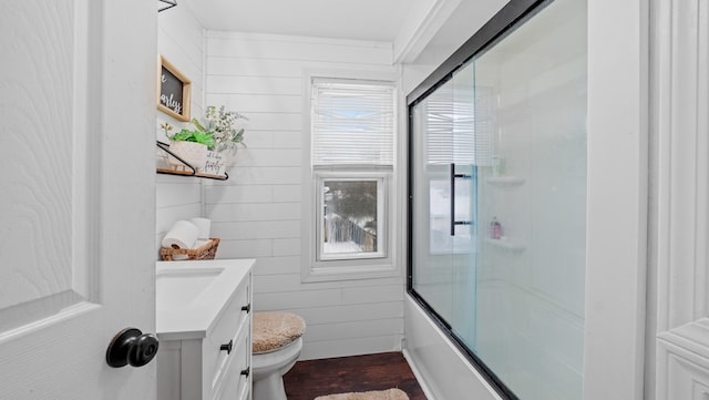 full bathroom featuring shower / bath combination with glass door, vanity, and toilet