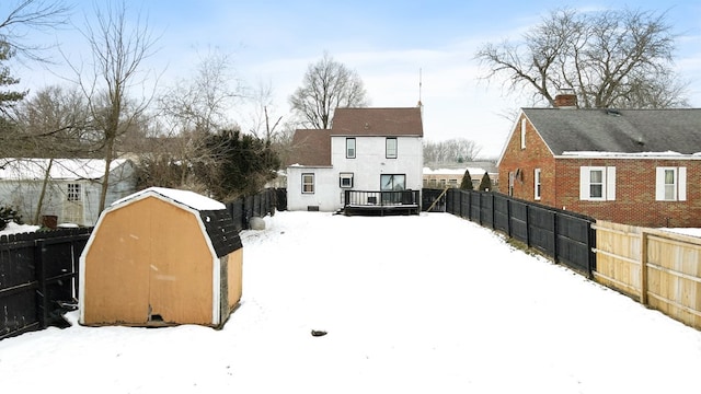 snowy yard featuring a wooden deck