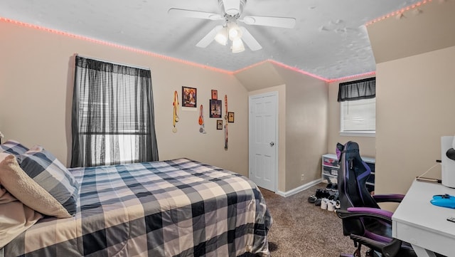 carpeted bedroom with ceiling fan, a textured ceiling, and lofted ceiling