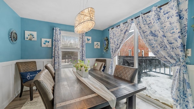 dining room with light wood-type flooring and a chandelier