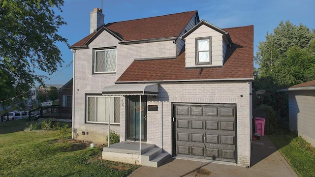 view of front facade with a front yard and a garage