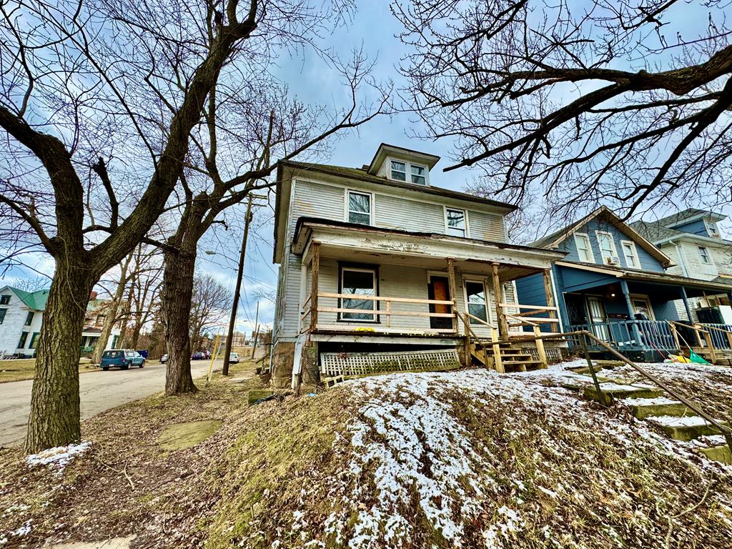 american foursquare style home with covered porch