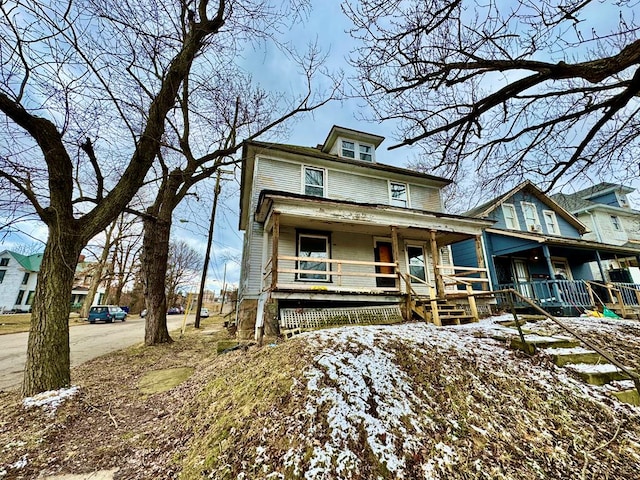 american foursquare style home with covered porch