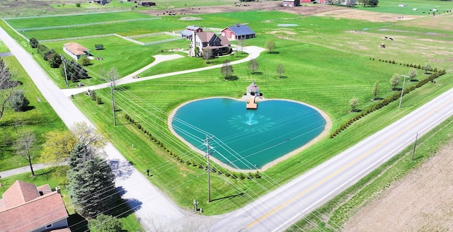 birds eye view of property featuring a water view and a rural view