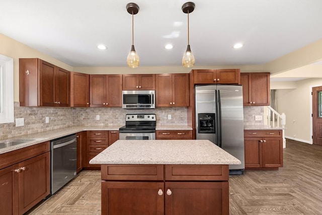828 Longmeadow Ln, Findlay, OH 45840 - kitchen with appliances with stainless steel finishes, a center island, backsplash, decorative light fixtures, and light stone countertops