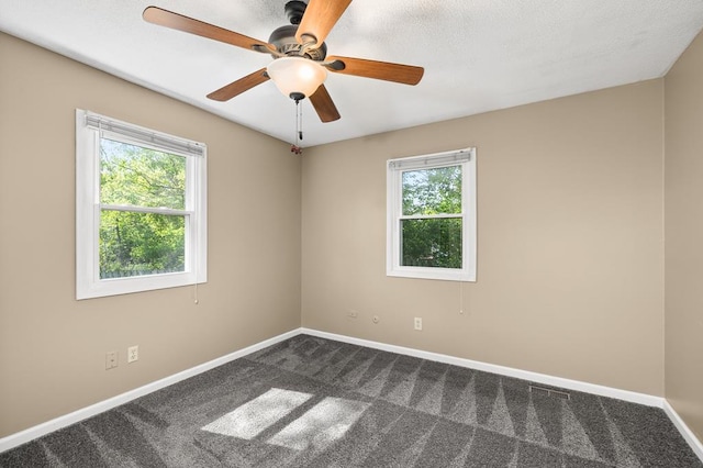 828 Longmeadow Ln, Findlay, OH 45840 - spare room featuring healthy amount of natural light, dark carpet, baseboards, and a ceiling fan