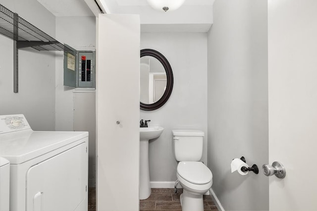 828 Longmeadow Ln, Findlay, OH 45840 - half bathroom featuring toilet, electric panel, separate washer and dryer, baseboards, and wood finished floors