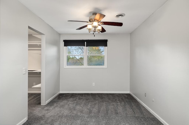 828 Longmeadow Ln, Findlay, OH 45840 - unfurnished bedroom with a spacious closet, carpet, baseboards, a closet, and a ceiling fan