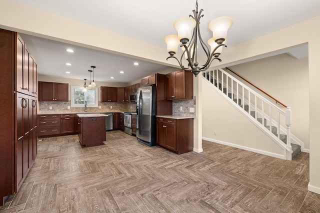 828 Longmeadow Ln, Findlay, OH 45840 - kitchen featuring stainless steel appliances, a chandelier, a center island, backsplash, and light countertops